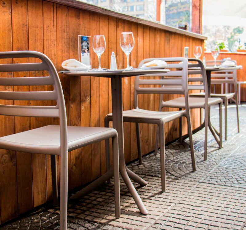 NARDI Costa Bistro Chairs in Taupe with Spritz Table in Taupe in Restaurant