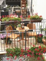 Costa Balcony Setting - Spritz Table & Costa Chairs, Pictured in Orange on Wooden Balcony Setting
