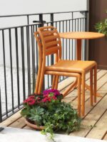 Costa Balcony Setting - Spritz Table & Costa Chairs, Pictured with Chairs Stacked on Apartment Balcony