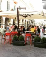 NARDI Faro Tall Bar Stools in Red and Taupe at outdoor street café