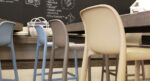 NARDI Faro Breakfast Bar Stools at wooden bench in an indoor cafe