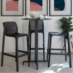 NARDI Net Tall Bar Stools in Charcoal around an Indoor Bar Leaner