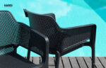 Two Net Chairs in Charcoal - Pictured on Wooden Deck next to Pool