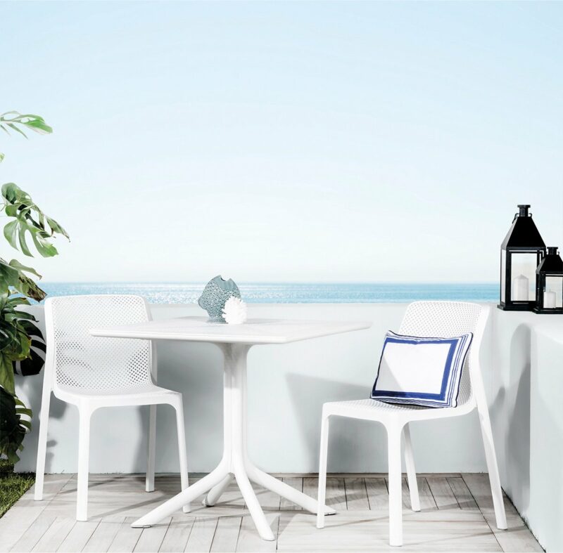 The bit clip 3 piece bistro set in white pictured on deck with a view
