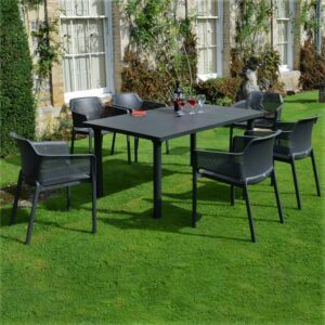 The Net Levante 7 Piece Dining Set in Charcoal Pictured Outside a Country Home Garden