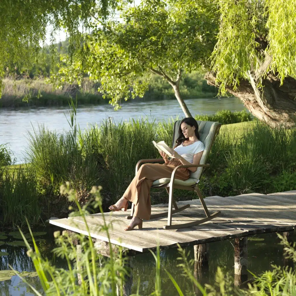 Nardi folio cushiond rocking chair girl reading on deck