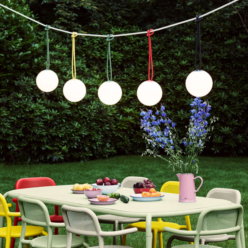 Fatboy® bolleke spherical lamps hanging over outdoor dining set