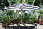 Fatboy® Bolleke Spherical Lamps over Dining Set Hanging from Umbrella